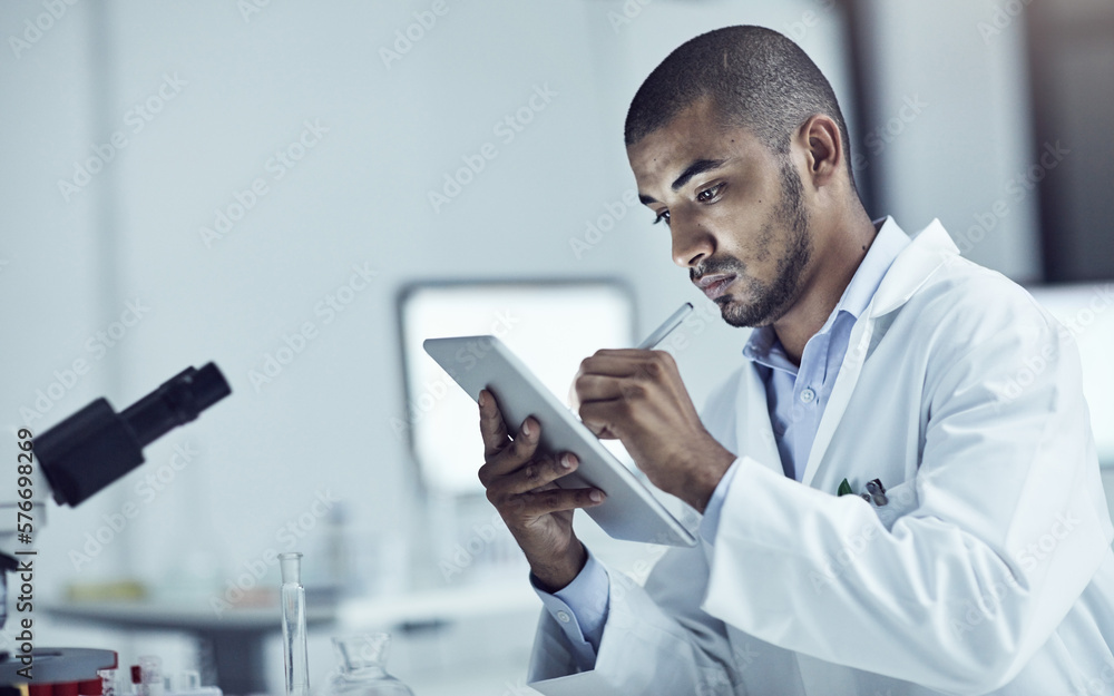 Aufkleber research plays a big role in solving problems. shot of a scientist recording his findings on a digit