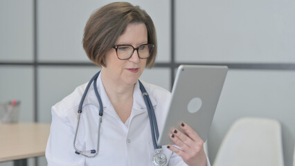 Online Video Chat by Senior Doctor on Tablet