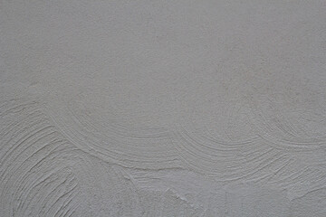 Texture of plaster cement wall is uneven and still wet for background.