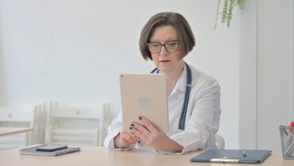 Senior Doctor Doing Online Video Chat via Tablet