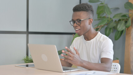 Young African Man Doing Video Chat on Laptop