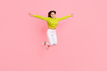 Full body photo of lovely teen lady jump spread arms flight bird playful dressed stylish green...