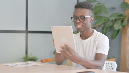 Young African Man Cheering Win on Digital Tablet