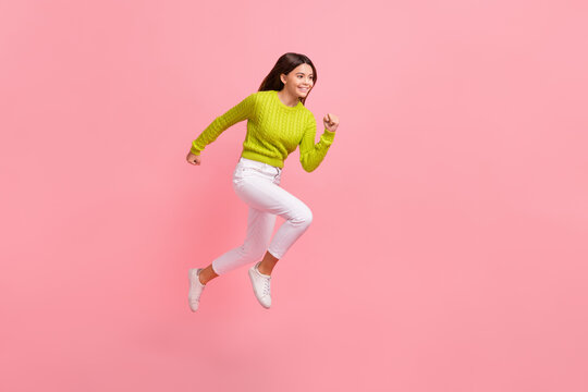 Full size photo of lovely teen lady jumping running sportive fast sales shopping wear trendy green look isolated on pink color background