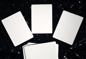 Mockup of 3 blank white tarot cards or learning cards and a deck with copy space. Template of three empty playing cards with space for text and images