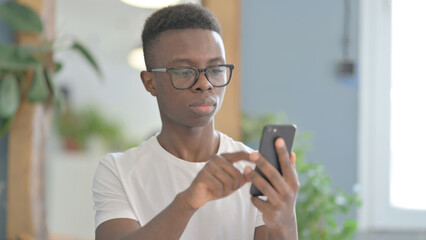 Portrait of Young African Man Using Smartphone