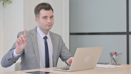 Young Businessman Shaking Head in Rejection while Working on Laptop