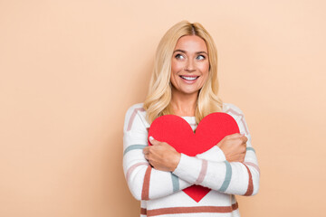 Portrait of cheerful optimistic girl wavy hairdo wear striped pullover hug big heart look empty space isolated on pastel color background