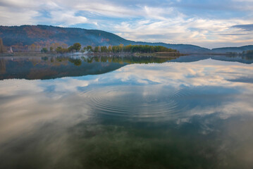 Obraz premium Different views of Golcuk Lake near to Izmir Province, beautiful reflection on water and colors of nature with clouds on blue sky