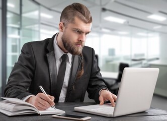 Busy businessman working in office on computer