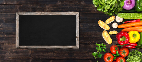 vegetables on wooden table with a  blackboard