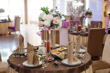 wedding decor.Wedding. Banquet. Chairs, table, flowers and crockery. Wedding decoration ceremony.