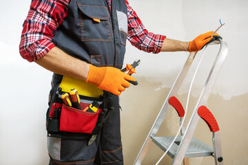 Electrician installing wiring on site. electrical wiring concept.