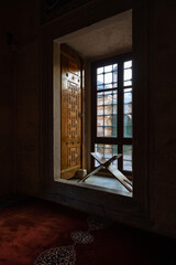 Islamic or ramadan concept photo. A lectern in front of a window of a mosque