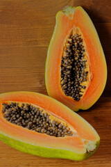 Fresh papaya fruit halved. Two halves of sweet tropical fruit.