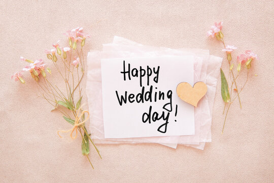 Happy wedding day - card with text, flowers and heart on pink background