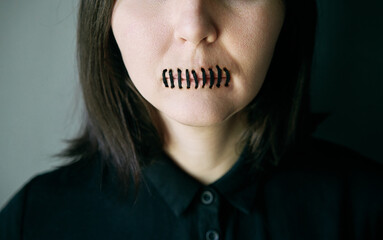 Woman with stitched mouth