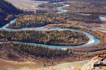 Turquoise twisting river in an autumn landscape