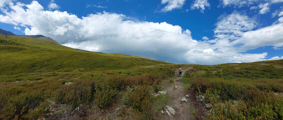 Lonely tourist goes on a high-mountainous plateau