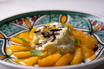 Spiced oranges with cloves and cinnamon served with organic honey and grated chocolate.