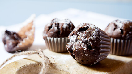 Chocolate muffins with chocolate chips inside.