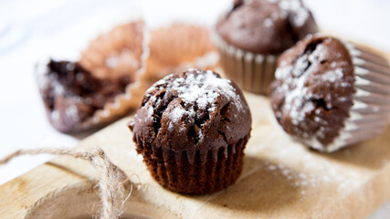Chocolate muffins with chocolate chips inside.
