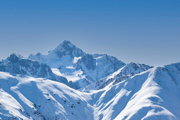View of Nursultan Peak from a forest pass in winter near Almaty