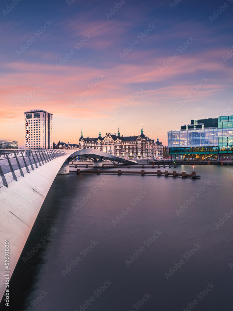 Wall mural lille langebro cycle and pedestrian bridge and city buildings after sunset in copenhagen, denmark