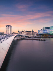 Lille Langebro cycle and pedestrian bridge and city buildings after sunset in Copenhagen, Denmark