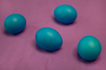 Blue Easter eggs on a purple tablecloth. Religion, easter concept.
