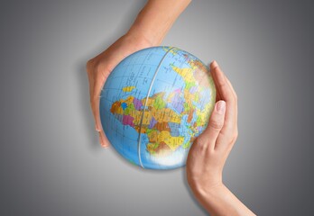 Human hands hold earth globe