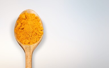 Tasty aroma seasoning in spoon on background