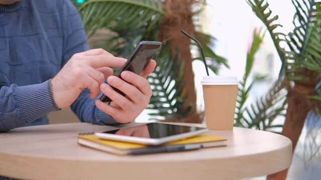 Closeup Of Businessman Mobile Phone, Writes On Smartphone Using Two Hands With Window At Background.