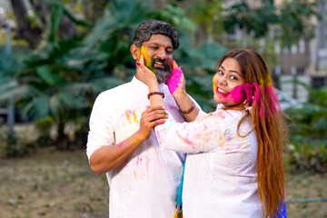 Indian people celebrate holi festival together at park.