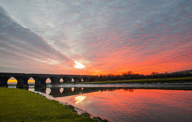 Red winter sunset over the Eleven Arches Viaduct, in Hendy, Swansea, South Wales