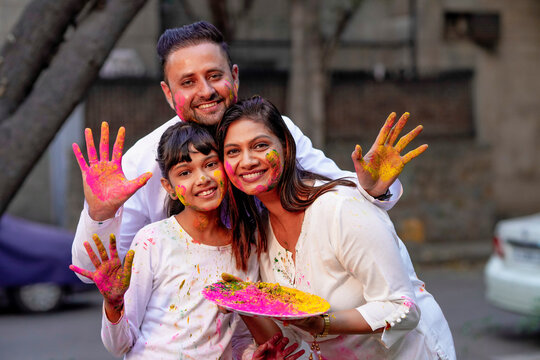 young indian family celebrating holi festival