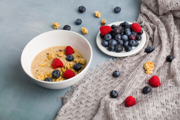 Healthy breakfast concept with oat flakes and fresh berries on rustic background. muesli. strawberries, blueberries