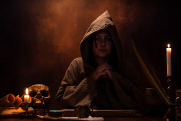 Witch in the Middle Ages sit at the table