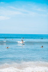 Surfing. A surfer on the waves in the ocean off the coast of Asia on the island of Bali in Indonesia. Sports and extreme. Beauty and health. Fashion and beach style.