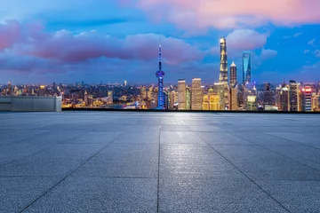 Gordijnen Empty square floor and city skyline with modern building at night in Shanghai, China. © ABCDstock