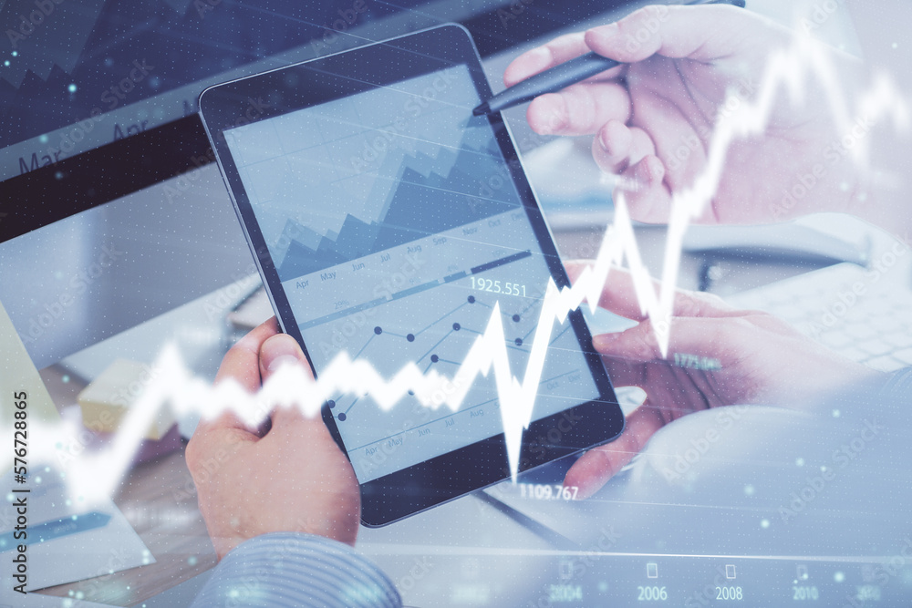 Poster double exposure of man's hands holding and using a phone and financial chart drawing. market analysi