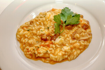 Risotto with pumpkin, porcini mushrooms and smoked scamorza cheese. Italian pasta. Italian food