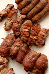 Mixed roast meat. Gnummareddi or torcinelli, rolls based on lamb offal, sausage and the famous bombette martinesi, meat rolls stuffed with cheese. Apulian food