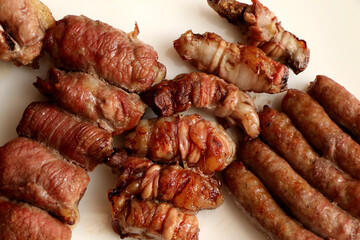 Mixed roast meat. Gnummareddi or torcinelli, rolls based on lamb offal, sausage and the famous bombette martinesi, meat rolls stuffed with cheese. Apulian food