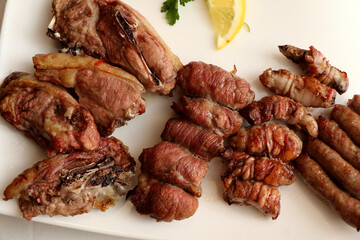 Mixed roast meat. Lamb, gnummareddi or torcinelli, rolls based on lamb offal, sausage and the famous bombette martinesi, meat rolls stuffed with cheese. Italian food
