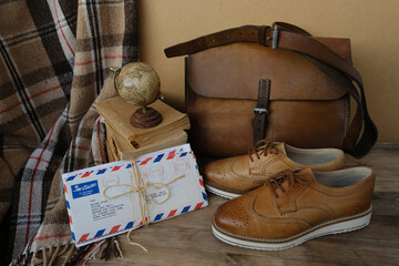 old nostalgic sentimental things, letters, stack of books, globe, shoes, vintage leather military...