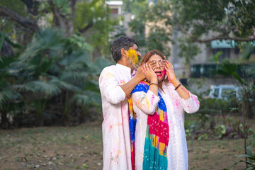 Indian people celebrate holi festival together at park.