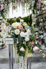Table for painting the newlyweds, decorated with a composition of fresh eustoma flowers, roses and eucalyptus. Wedding decoration concept