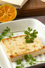 Grilled fried tofu on plate. Selective focus.