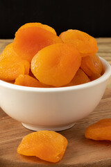 Dried apricot in white bowl.